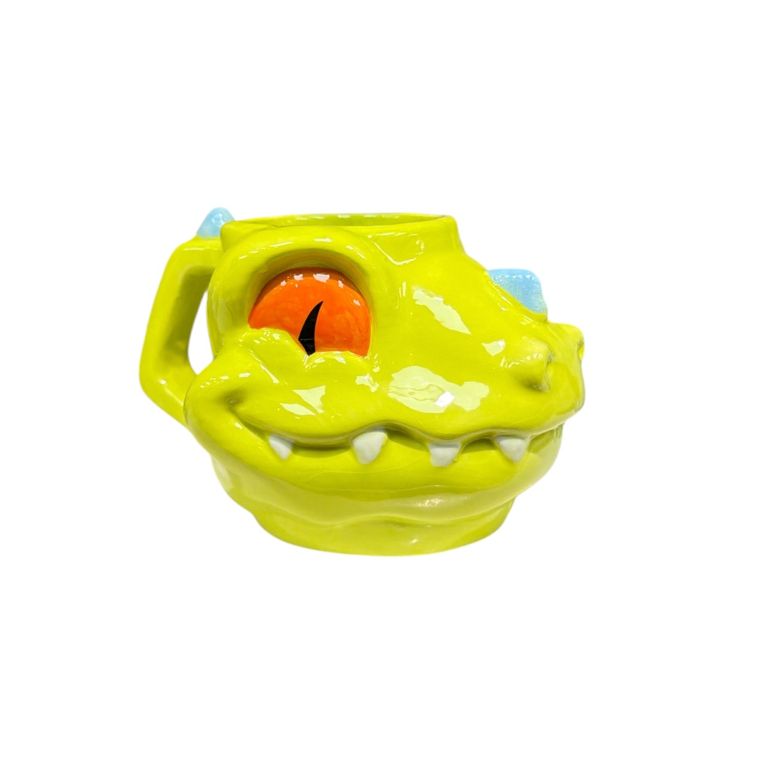 Taza cara dinosaurios verde ojos naranjas